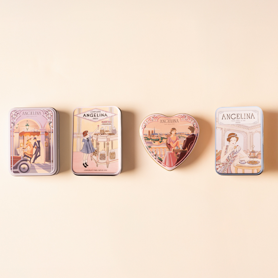 Four illustrated Angelina confectionery tins arranged in a row on a soft beige background.