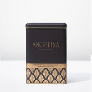 Elegant black and gold Angelina Paris tin filled with premium hot chocolate mix, featuring an Art Deco pattern and “Angelina Paris depuis 1903” printed on the front.